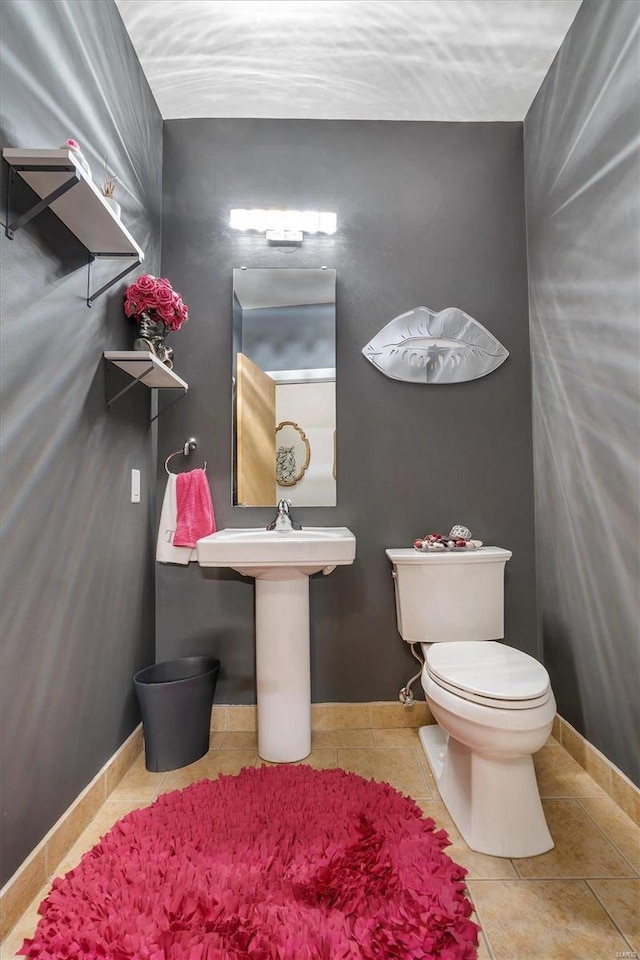 bathroom with toilet and tile patterned floors