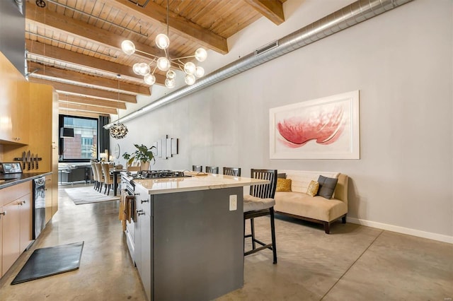 kitchen featuring a kitchen breakfast bar, hanging light fixtures, a center island, and beam ceiling