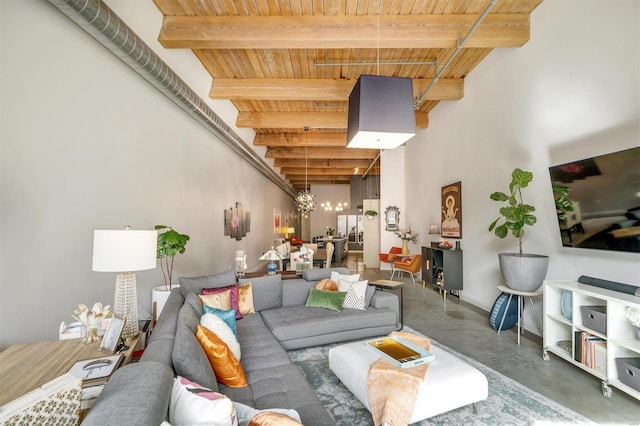 living room featuring wooden ceiling, beamed ceiling, and an inviting chandelier