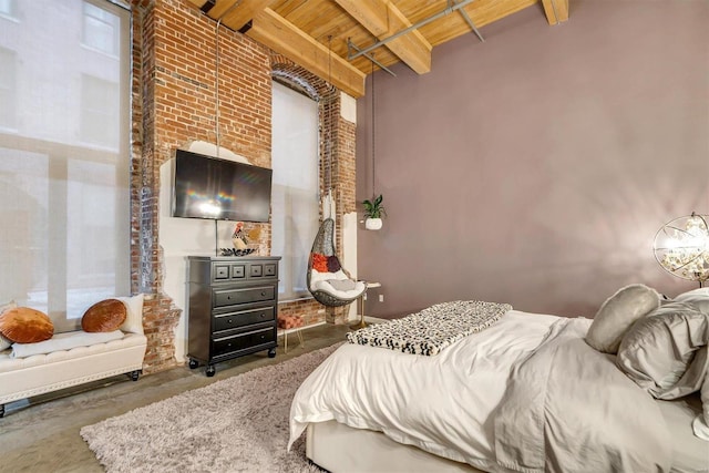 bedroom with wooden ceiling, beamed ceiling, and concrete flooring