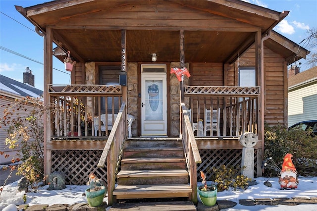 view of snow covered property entrance