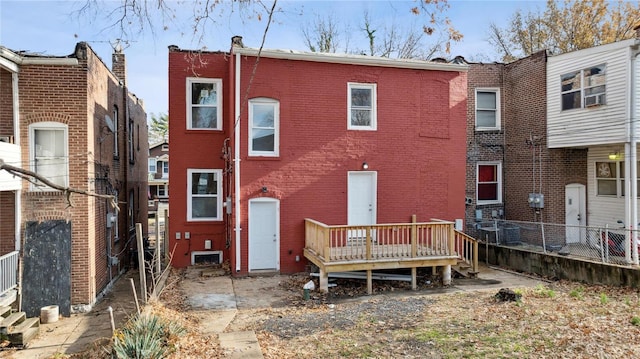 rear view of house featuring a wooden deck