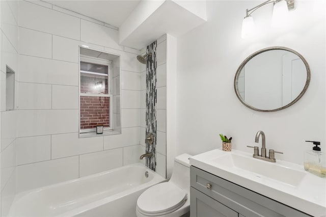 full bathroom featuring vanity, toilet, and tiled shower / bath combo