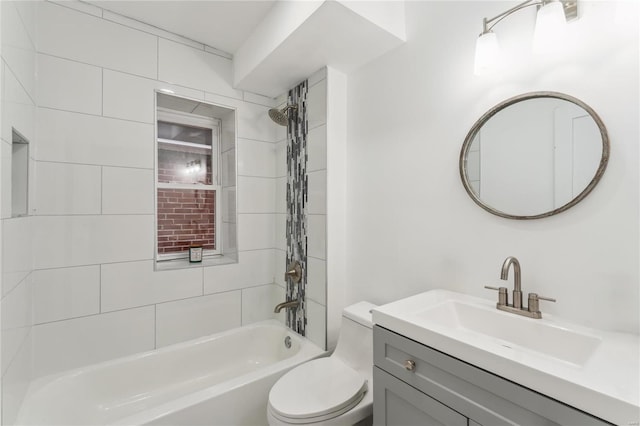 full bathroom with vanity, tiled shower / bath combo, and toilet