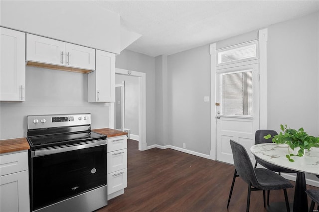 kitchen with dark hardwood / wood-style flooring, white cabinets, electric stove, and wood counters