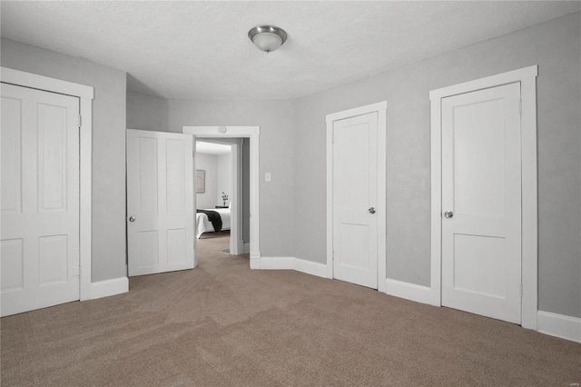 unfurnished bedroom featuring carpet flooring and a textured ceiling