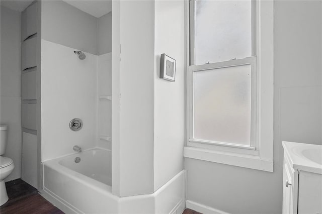 full bathroom featuring hardwood / wood-style flooring,  shower combination, vanity, and toilet