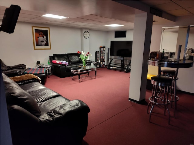 carpeted living room with a drop ceiling