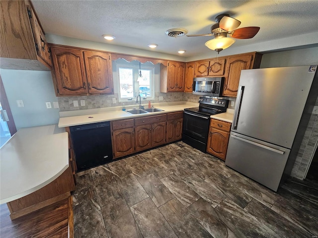 kitchen with a textured ceiling, black appliances, backsplash, ceiling fan, and sink