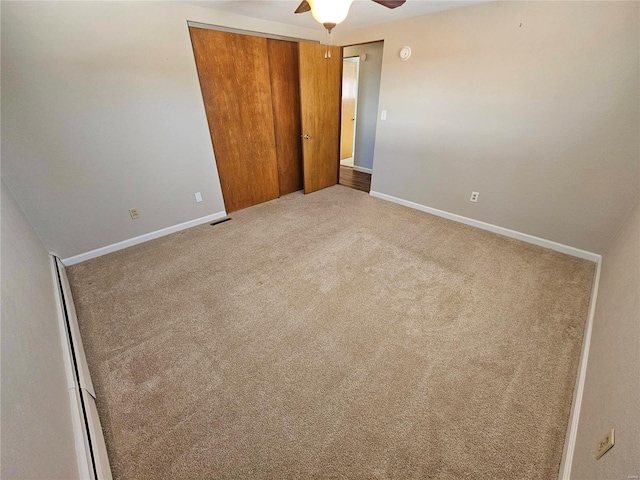 unfurnished bedroom with carpet flooring, a closet, and ceiling fan