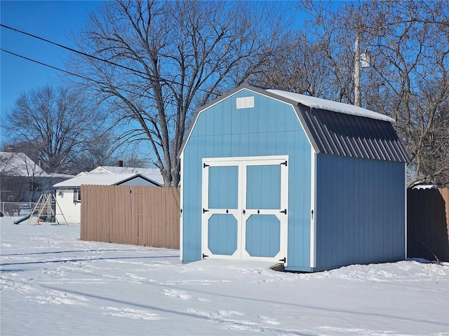 snow covered structure with a playground