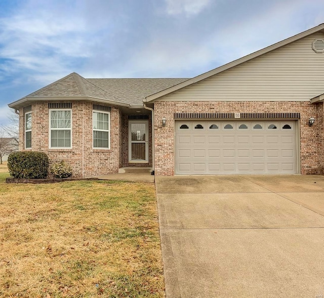 ranch-style home featuring a garage and a front lawn