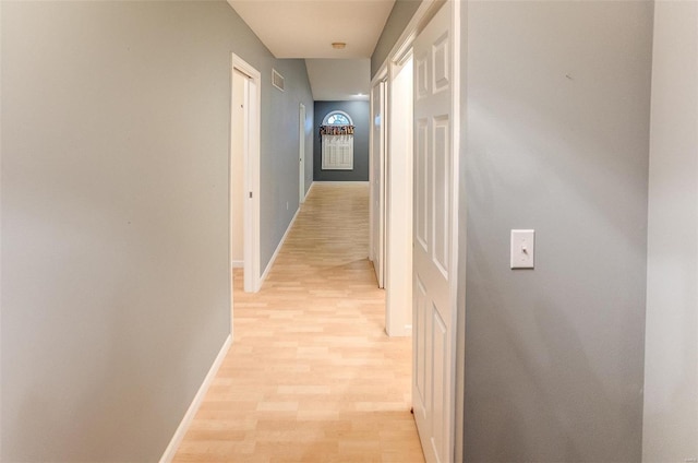 hallway with light hardwood / wood-style flooring