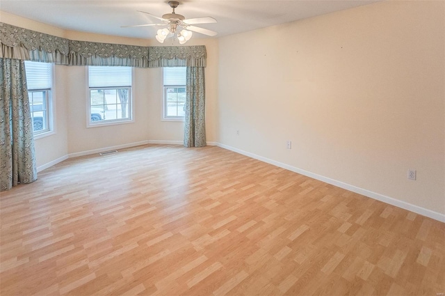 spare room featuring ceiling fan and light hardwood / wood-style flooring