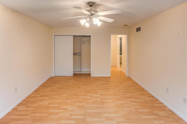 unfurnished bedroom with ceiling fan, light hardwood / wood-style floors, and a closet