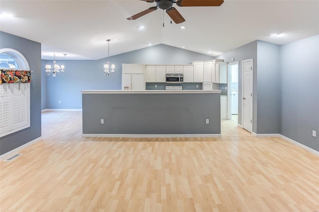 kitchen featuring white cabinetry, hanging light fixtures, white refrigerator with ice dispenser, and a spacious island