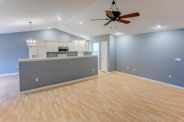 kitchen featuring ceiling fan with notable chandelier, pendant lighting, white refrigerator with ice dispenser, light hardwood / wood-style floors, and white cabinets