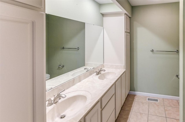 bathroom featuring vanity, toilet, and tile patterned flooring