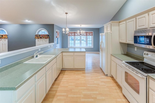 kitchen with sink, hanging light fixtures, kitchen peninsula, a notable chandelier, and white appliances