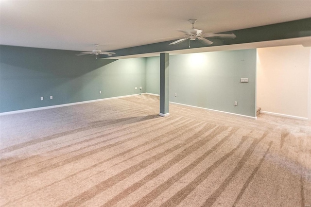 basement featuring light carpet and ceiling fan