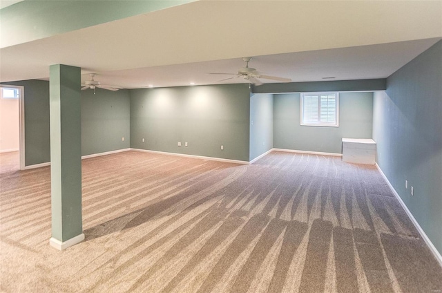 basement featuring ceiling fan and carpet flooring