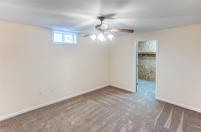 carpeted spare room with ceiling fan