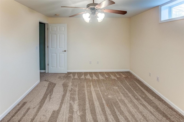 unfurnished room with light colored carpet and ceiling fan