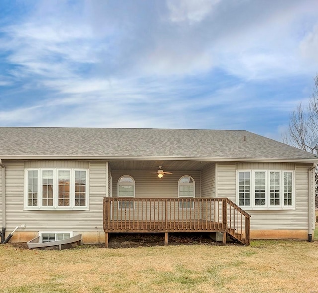 back of house with a wooden deck and a yard