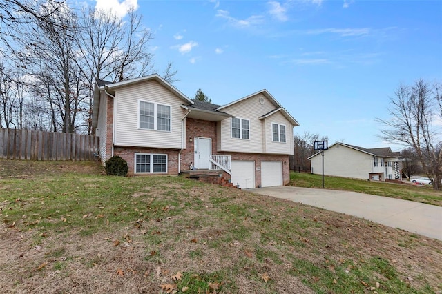 bi-level home featuring a front yard and a garage