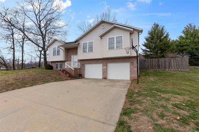 raised ranch with a front lawn and a garage