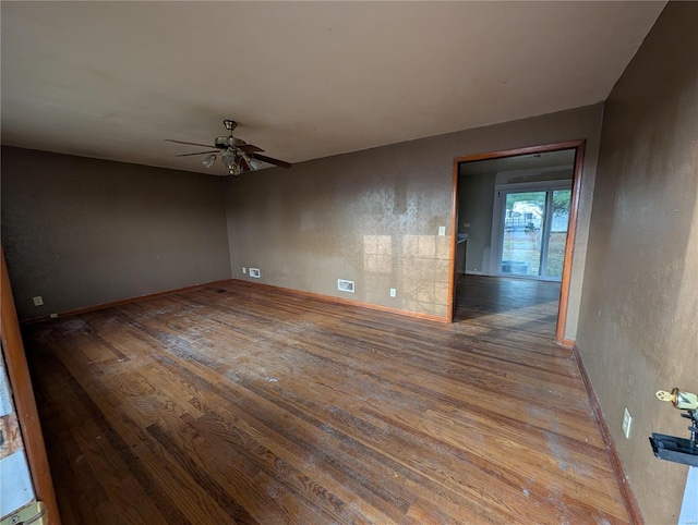 empty room featuring ceiling fan and hardwood / wood-style flooring