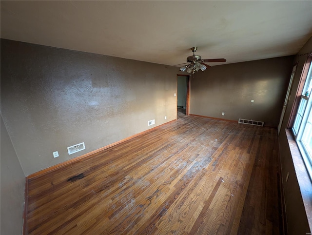 empty room featuring ceiling fan and hardwood / wood-style floors