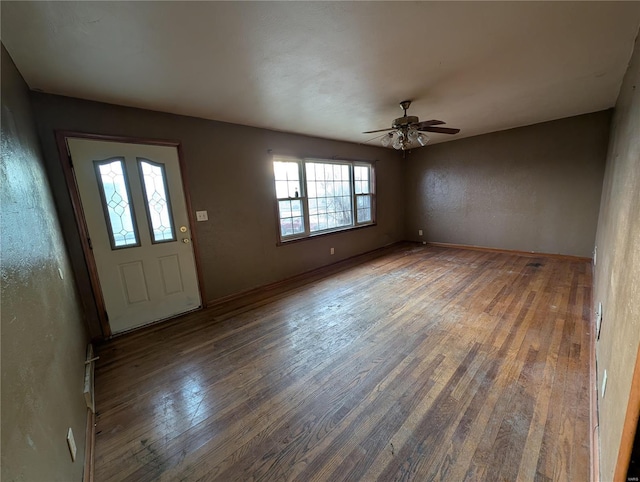 entryway with dark hardwood / wood-style flooring and ceiling fan