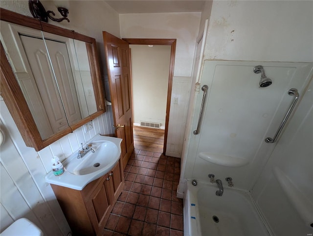 bathroom with a tub to relax in, tile patterned floors, and vanity