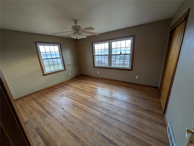 unfurnished bedroom with ceiling fan and light hardwood / wood-style floors