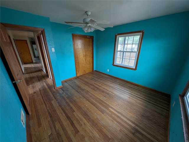 unfurnished bedroom featuring a closet, ceiling fan, and hardwood / wood-style flooring