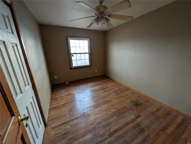 unfurnished room with ceiling fan and hardwood / wood-style floors