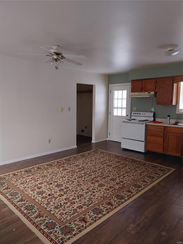 kitchen featuring white range with electric stovetop, ceiling fan, dark hardwood / wood-style flooring, and sink