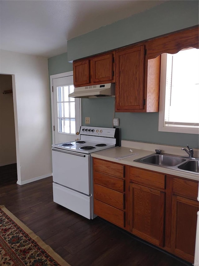 kitchen featuring dark wood-type flooring, white electric range, and sink