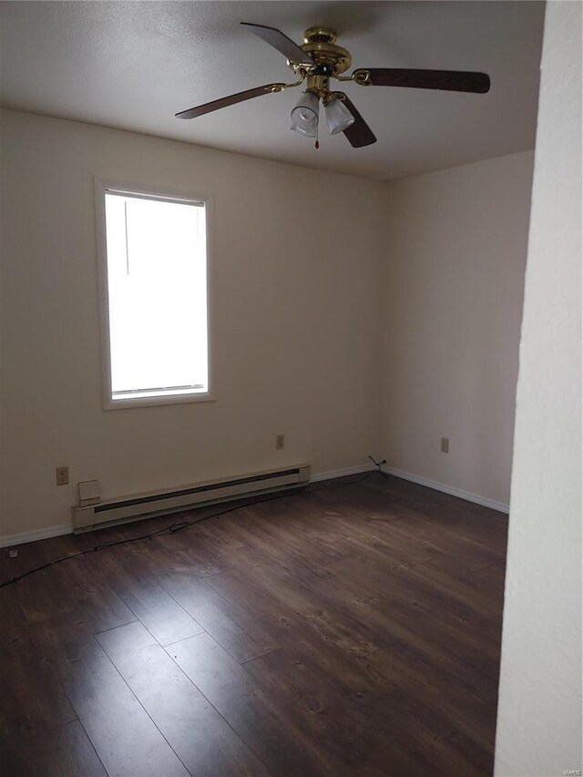 spare room featuring ceiling fan, dark hardwood / wood-style flooring, and a baseboard radiator