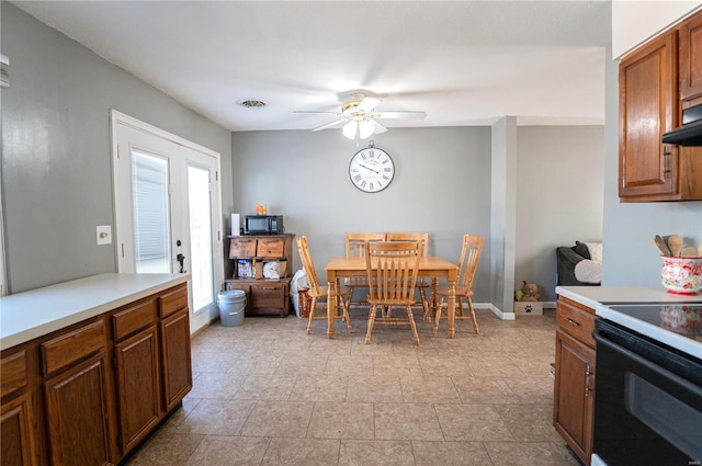 dining area featuring ceiling fan and french doors