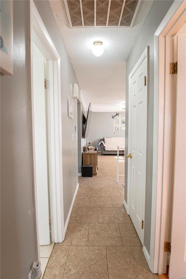 hallway featuring a textured ceiling