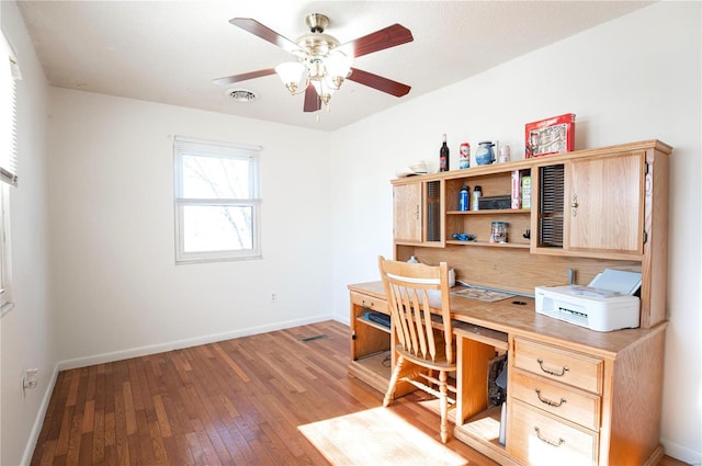 home office featuring ceiling fan and light hardwood / wood-style floors