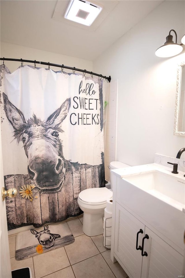 bathroom featuring tile patterned floors, toilet, a shower with shower curtain, and vanity