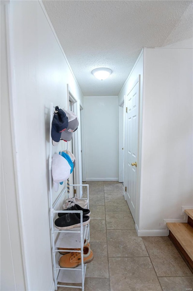 hallway with a textured ceiling