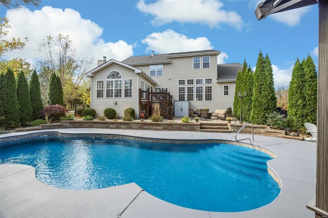 view of pool featuring a wooden deck and a patio area