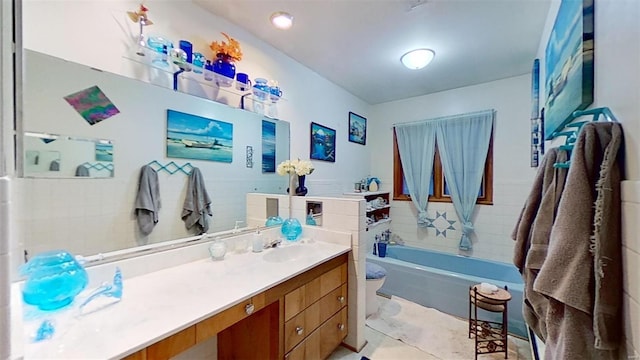 bathroom featuring vanity and a bath