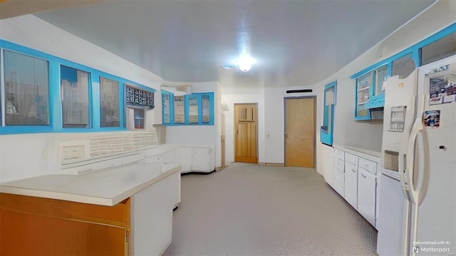 kitchen with white cabinets and white refrigerator with ice dispenser