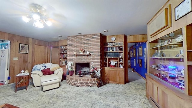 carpeted living room featuring a brick fireplace, wood walls, and a baseboard heating unit