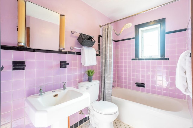 full bathroom featuring sink, tile walls, toilet, and shower / bath combination with curtain